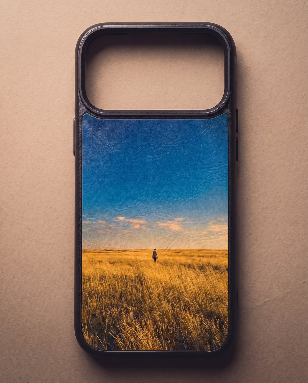 The back of a Kase Artist case filling the frame, printed edge to edge with a photograph of a lone figure walking through golden grassland under a wide blue sky