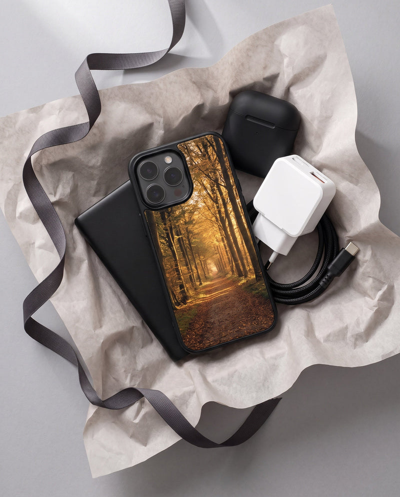 The Kase Artist gift set in tissue paper with a ribbon, a printed cover resting on the power bank beside the wall charger, cable and wireless earbuds